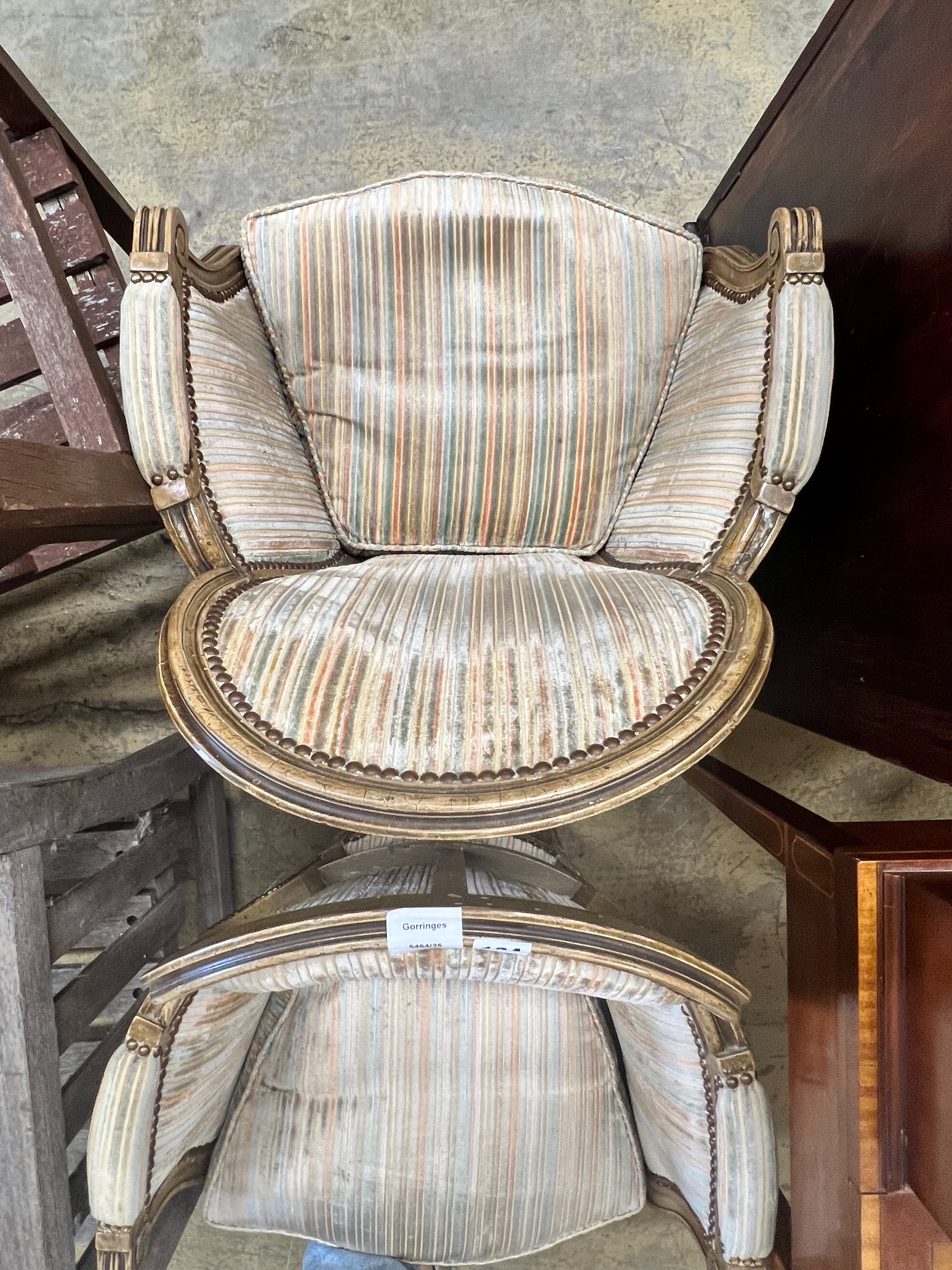 A pair of Louis XVI style painted cream show wood framed bergeres, upholstered in ribbed velvet, width 58cm depth 43cm height 86cm